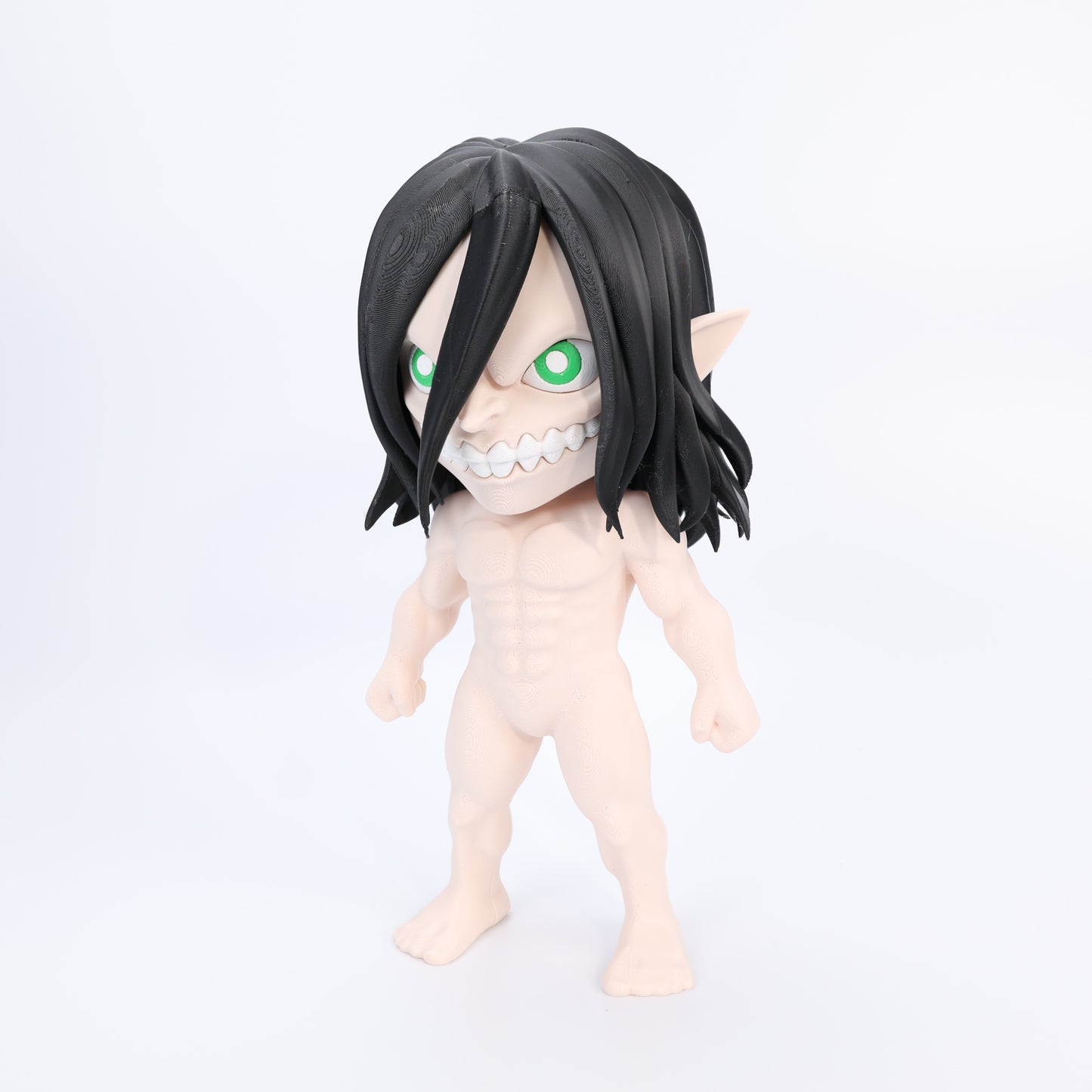 Toy figure with black hair and green eyes on a white background