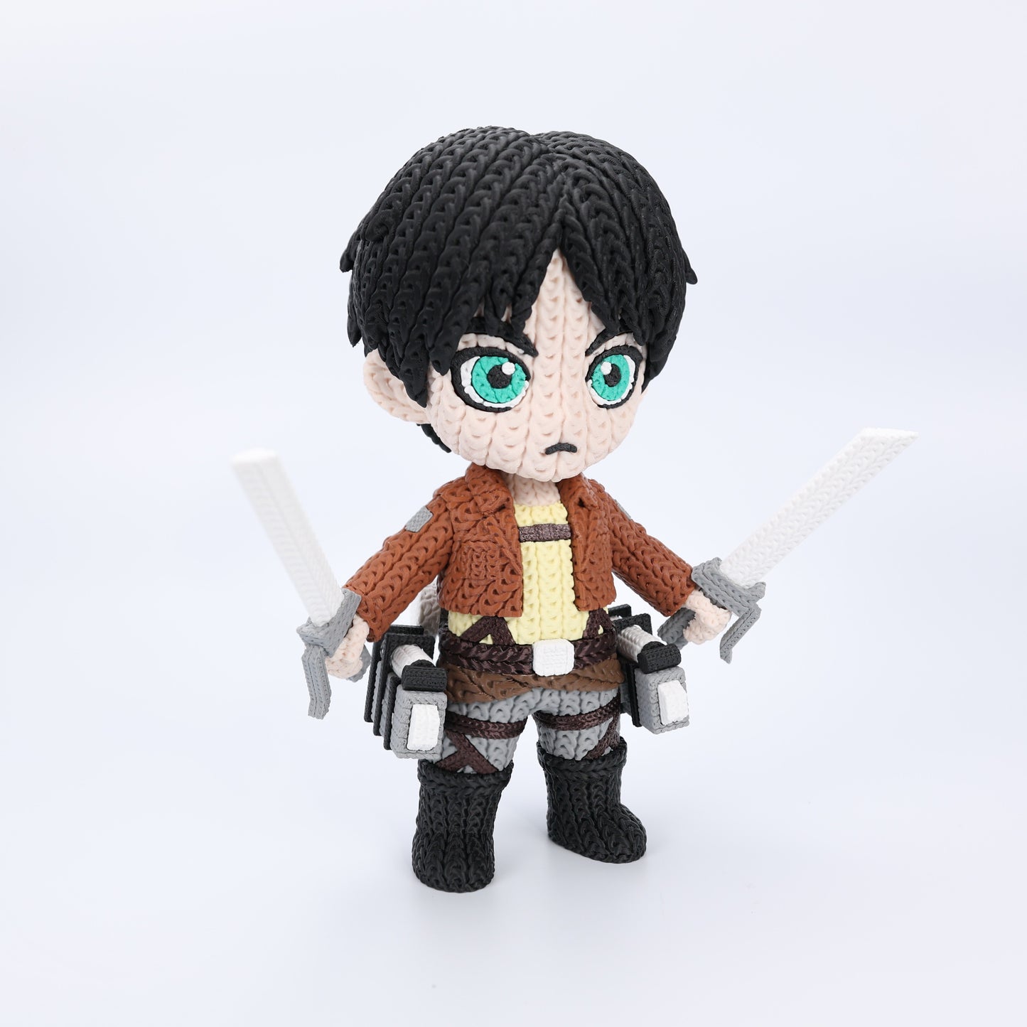 Crocheted textured character with black hair and green eyes, holding two swords on a white background.