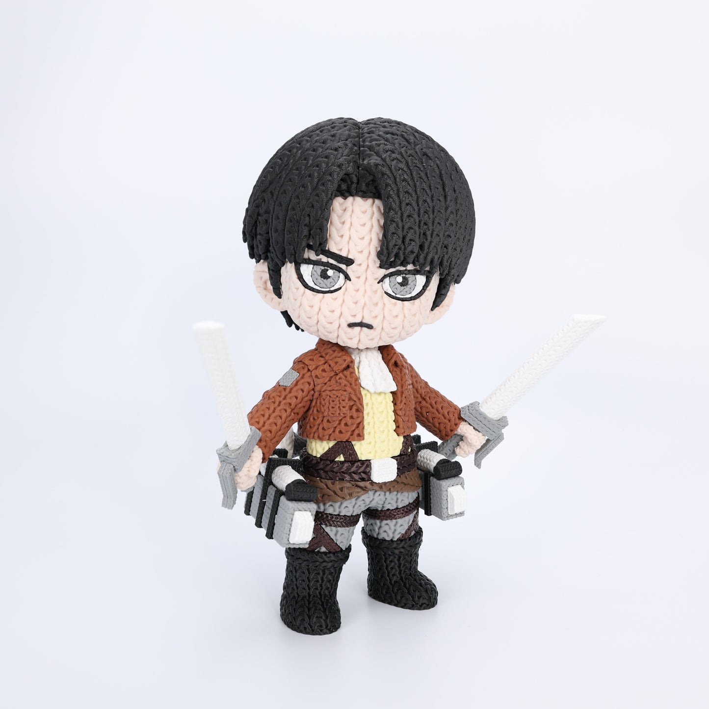 Knit texture toy figure of a character with dark hair and glasses on a white background